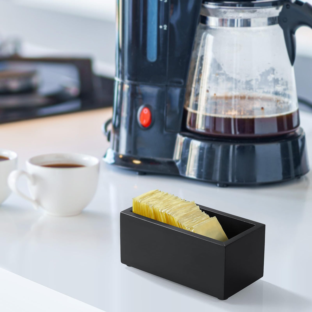 Sugar, right by the coffee