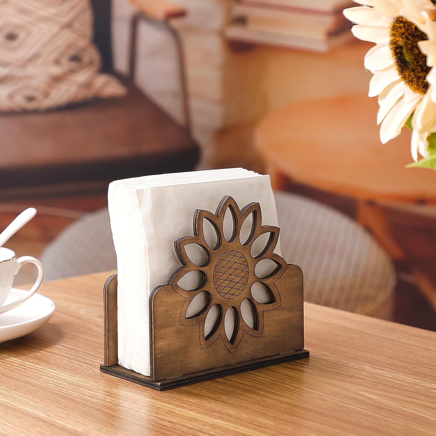 Wooden sunflower napkin holder with paper napkins on a café table