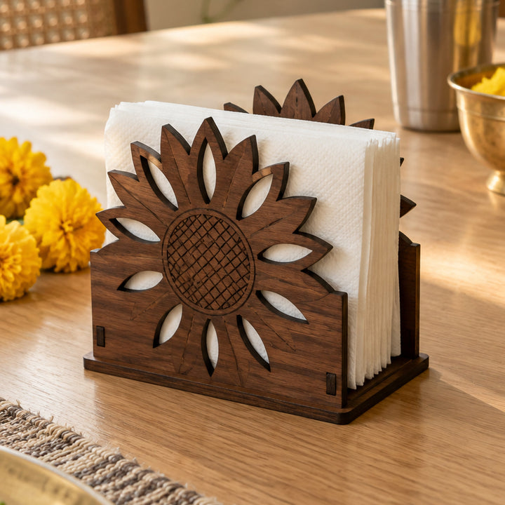 Wooden sunflower napkin holder with white paper napkins on a dining table